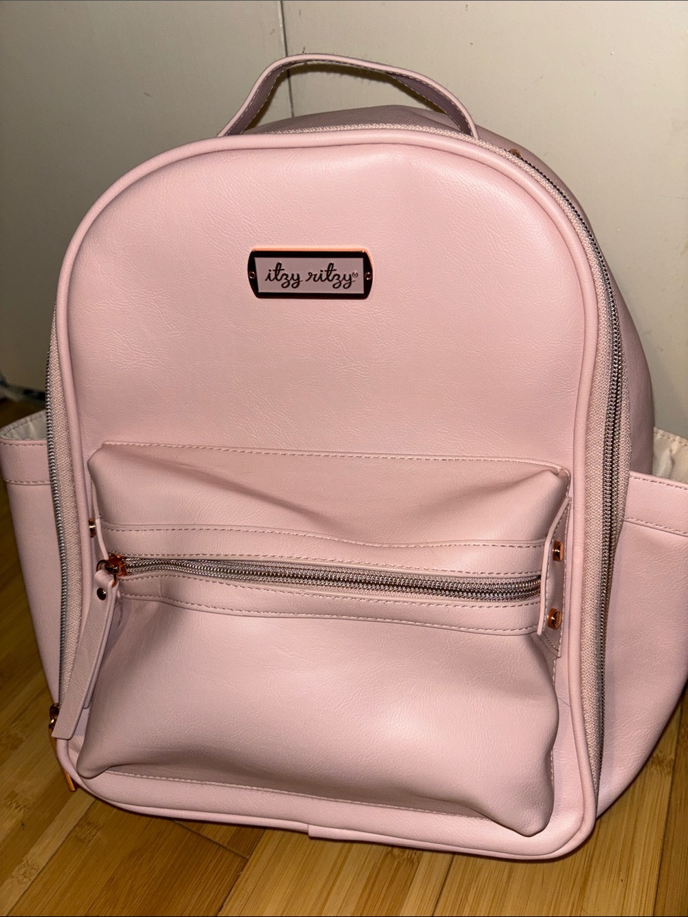 Itzy Ritzy Light Blush Pink Faux Leather Diaper Backpack with Rose Gold Accents